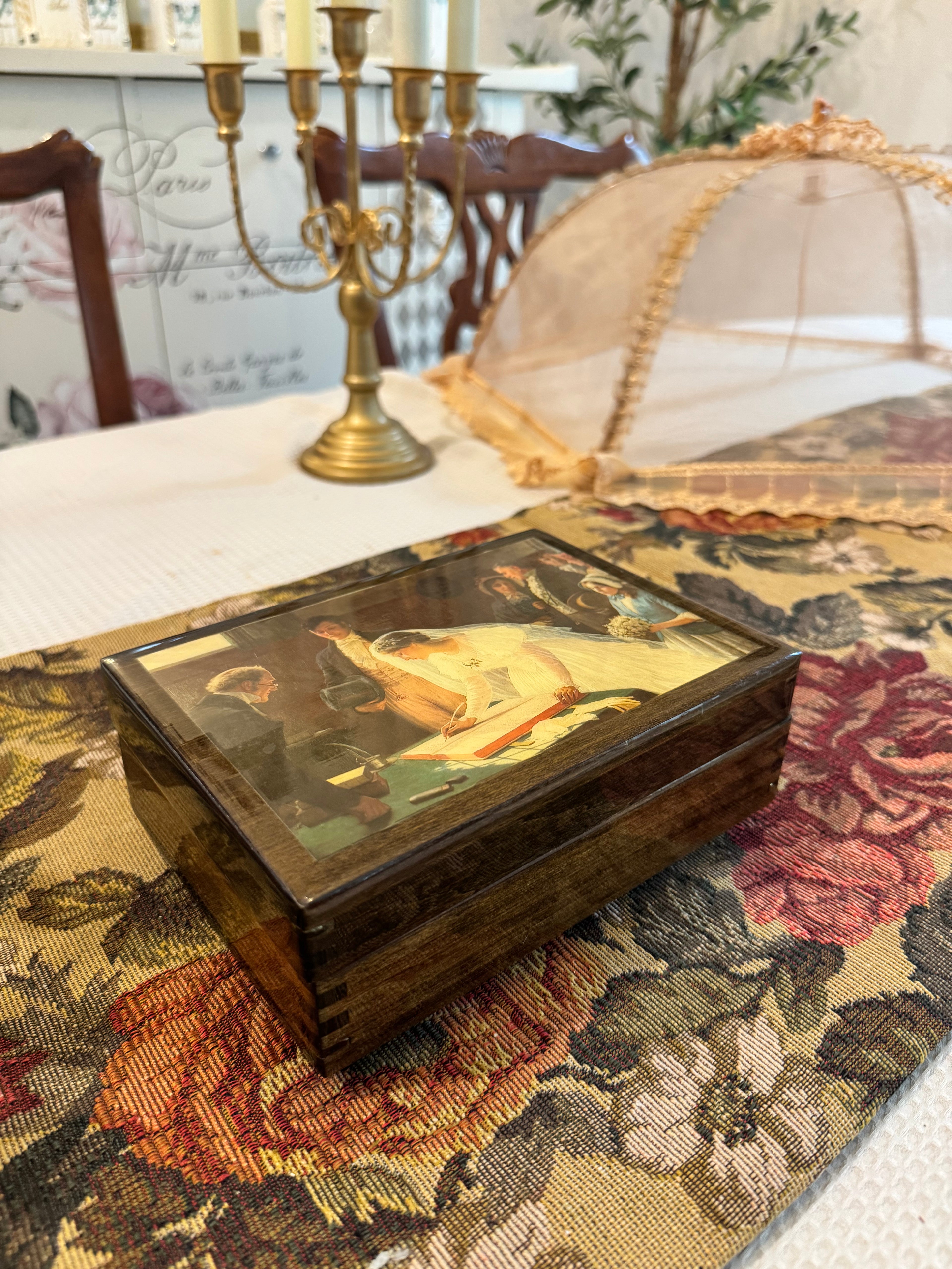 Wooden decorative musical jewelry box featuring a reproduction of the painting "The Wedding Register"