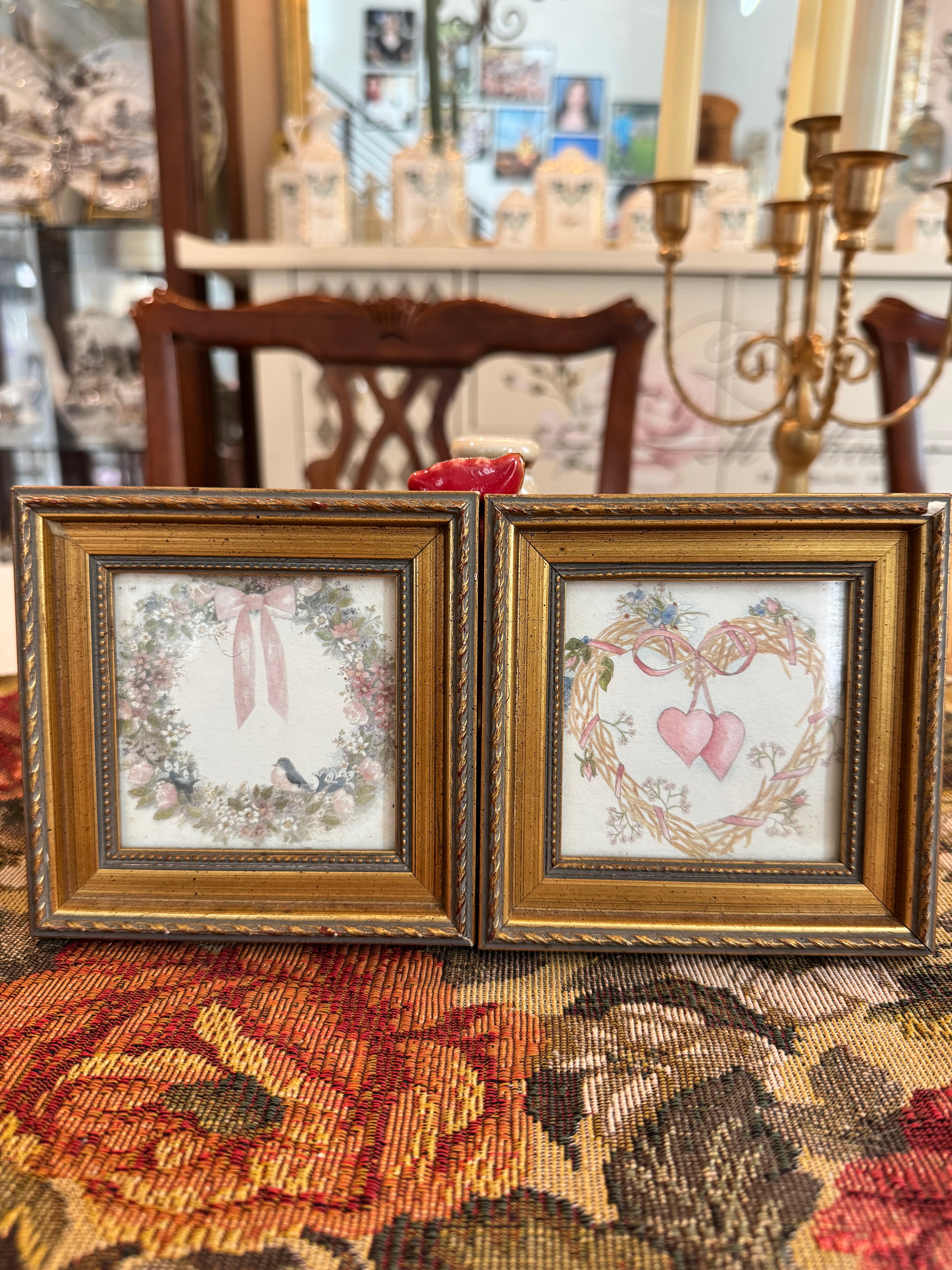 A pair of vintage framed prints by Homco with wreath and rosettes design by artist Bertrand