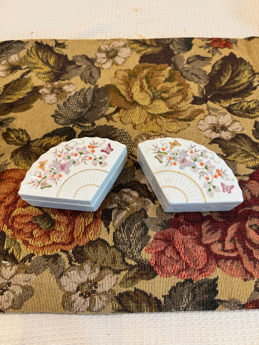 A pair of vintage 1980 Avon porcelain fan-shaped trinket boxes