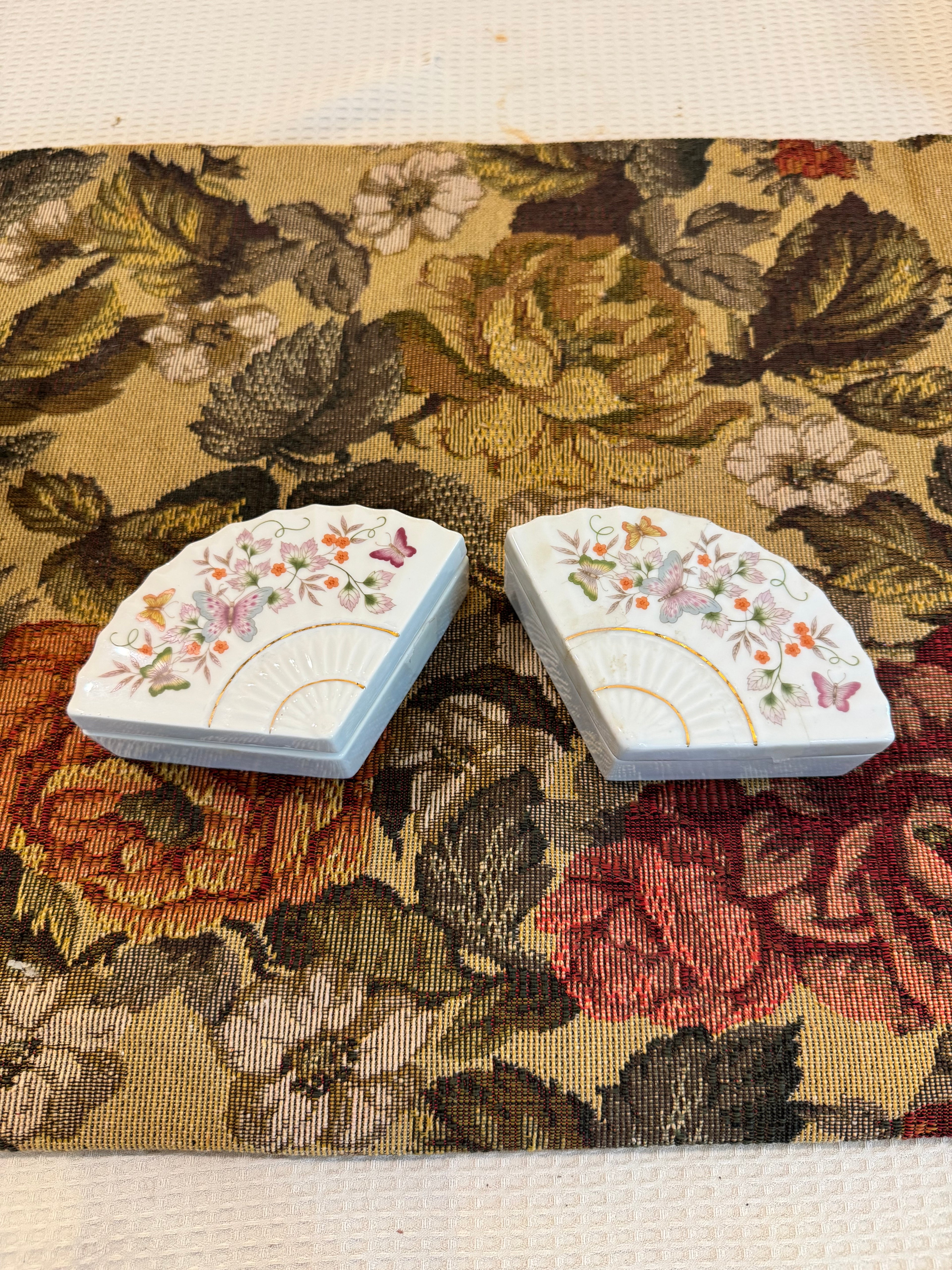 A pair of vintage 1980 Avon porcelain fan-shaped trinket boxes
