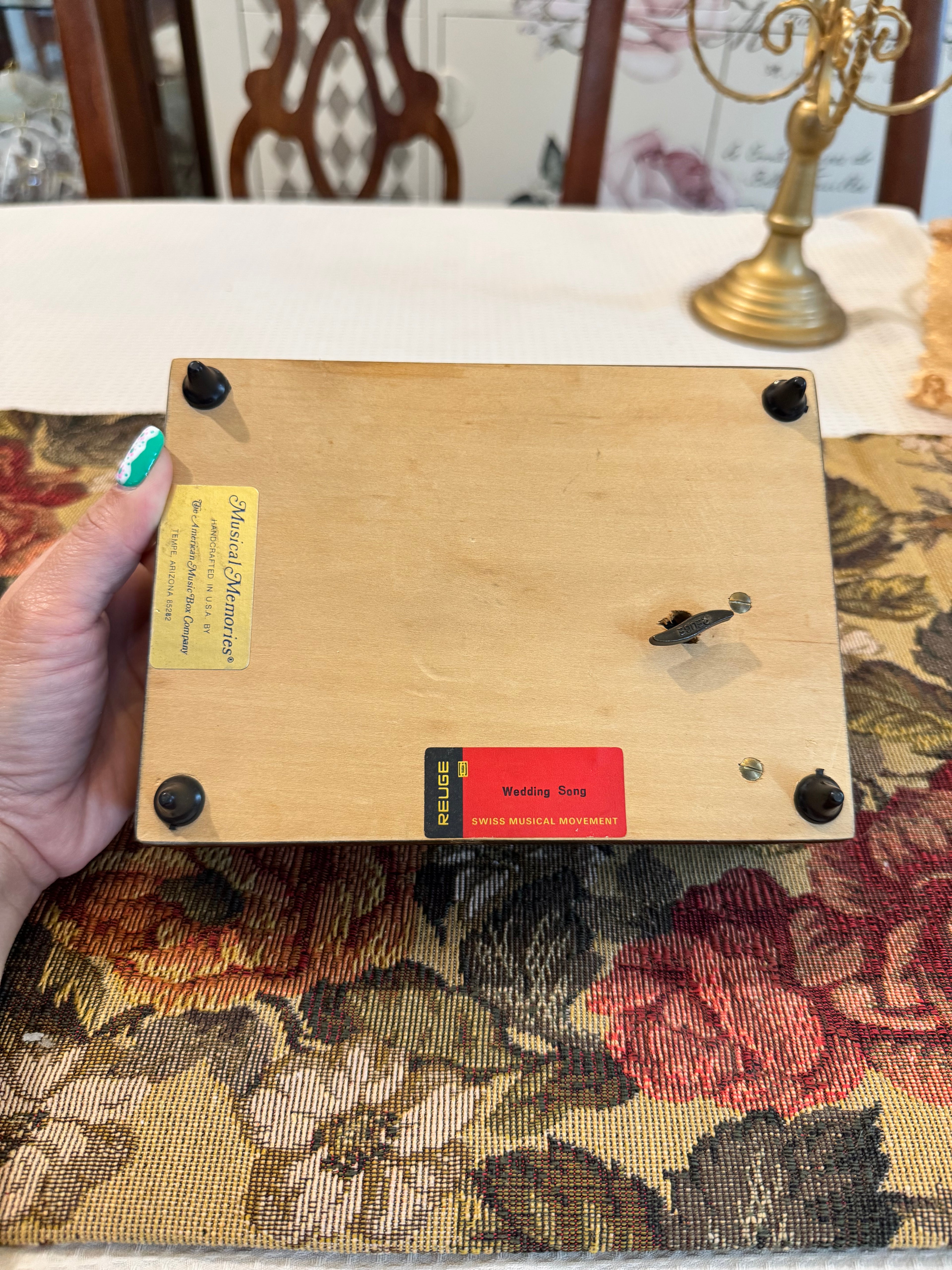 Wooden decorative musical jewelry box featuring a reproduction of the painting "The Wedding Register"