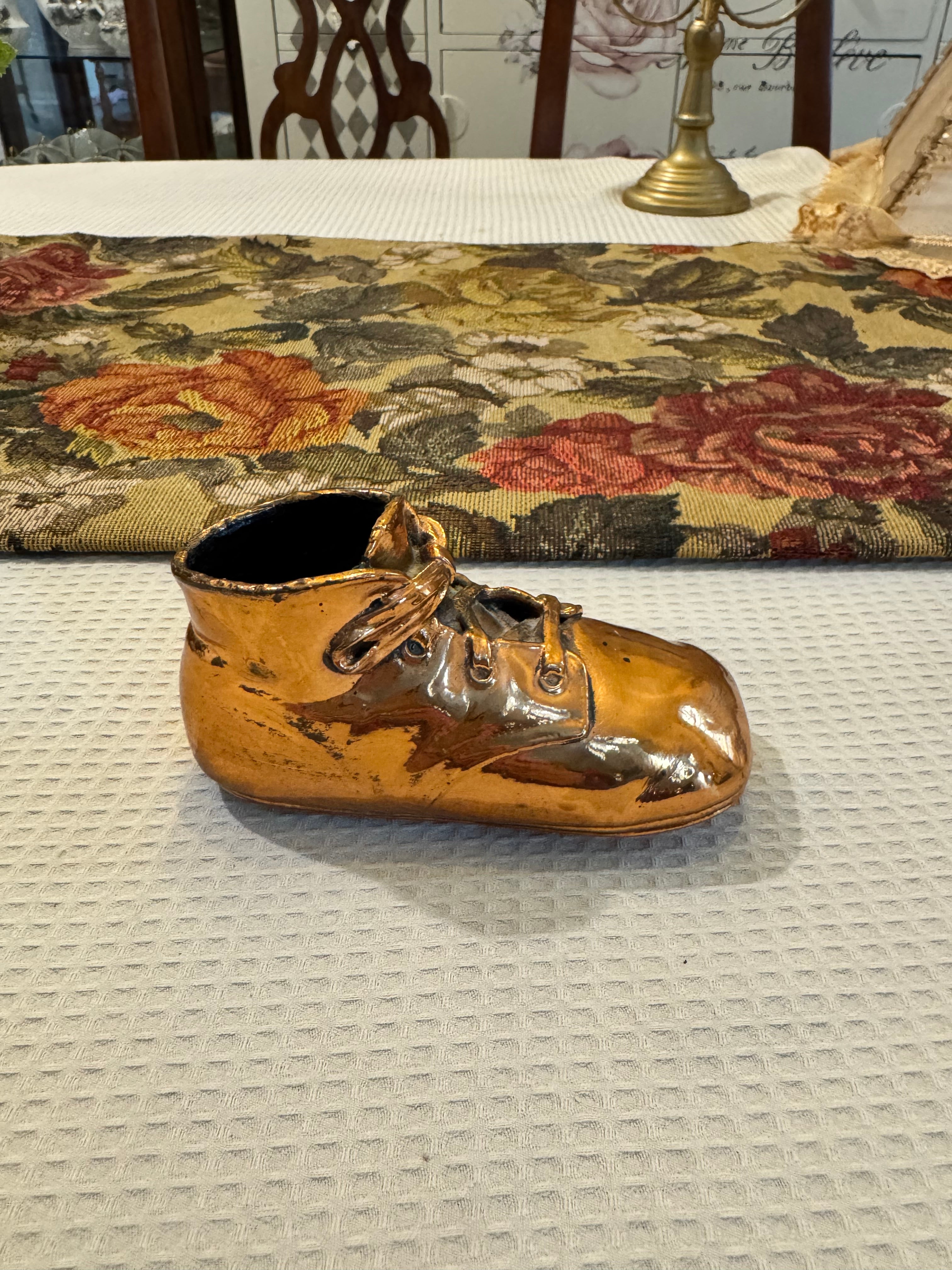 Vintage copper-dipped baby shoe