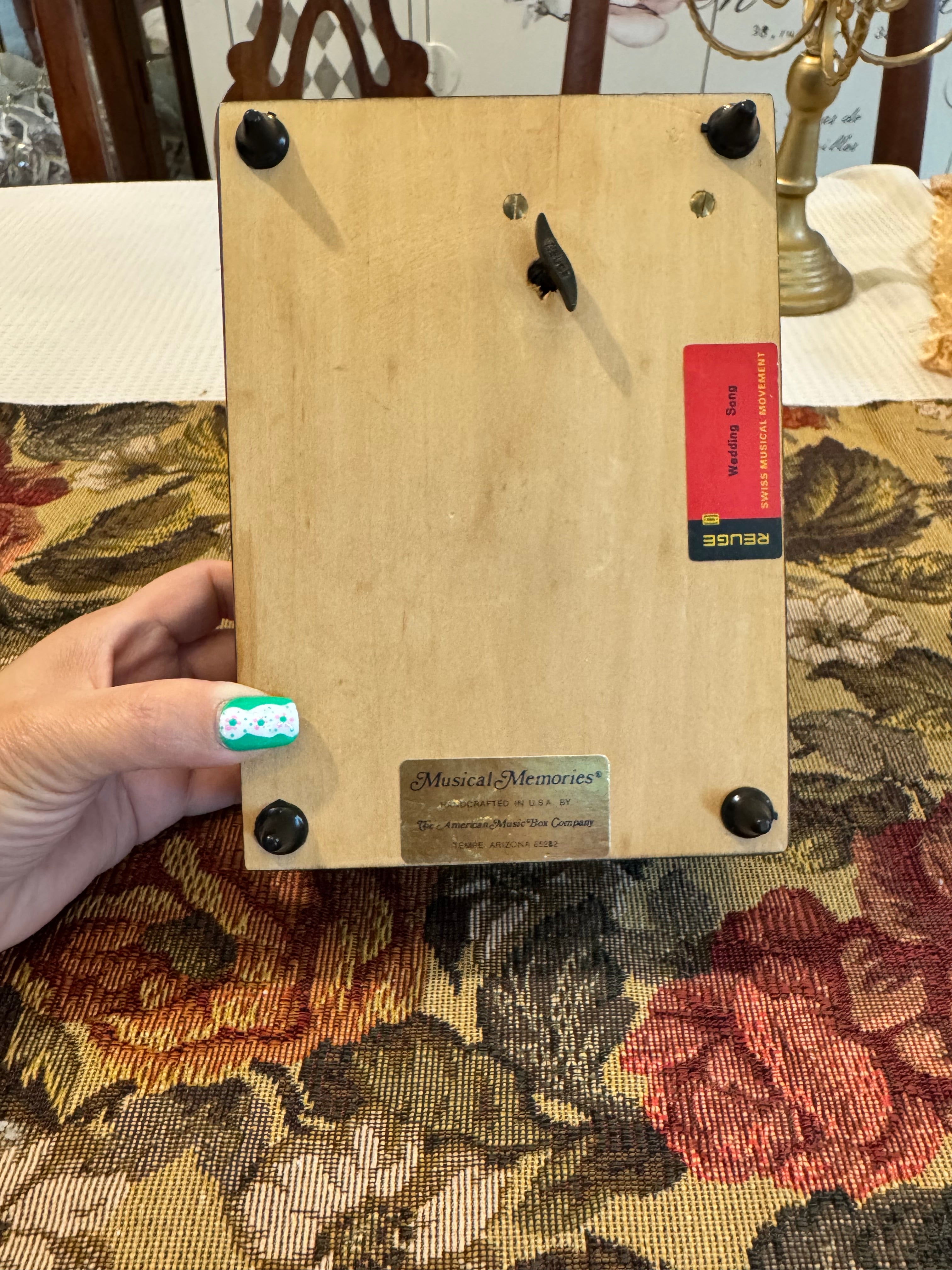 Wooden decorative musical jewelry box featuring a reproduction of the painting "The Wedding Register"