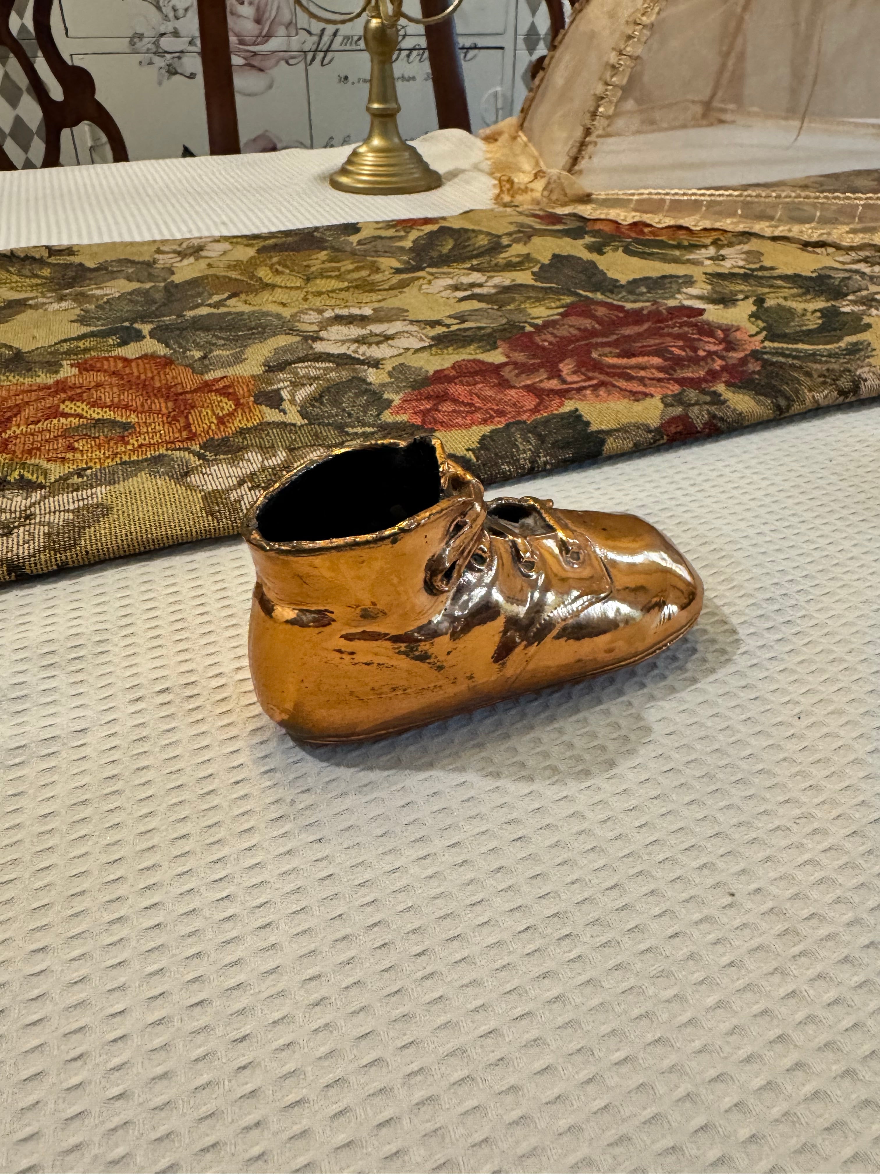 Vintage copper-dipped baby shoe