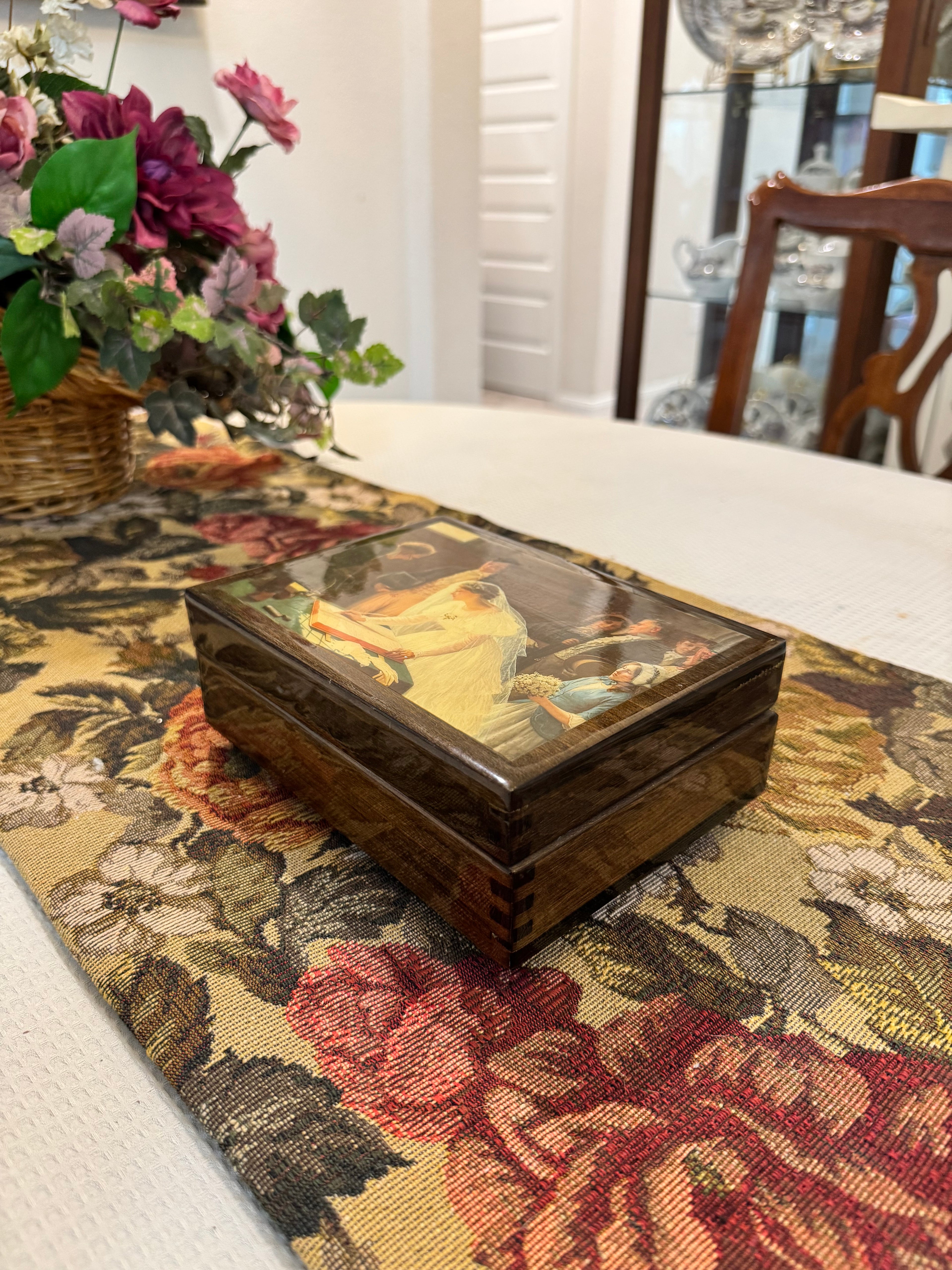 Wooden decorative musical jewelry box featuring a reproduction of the painting "The Wedding Register"