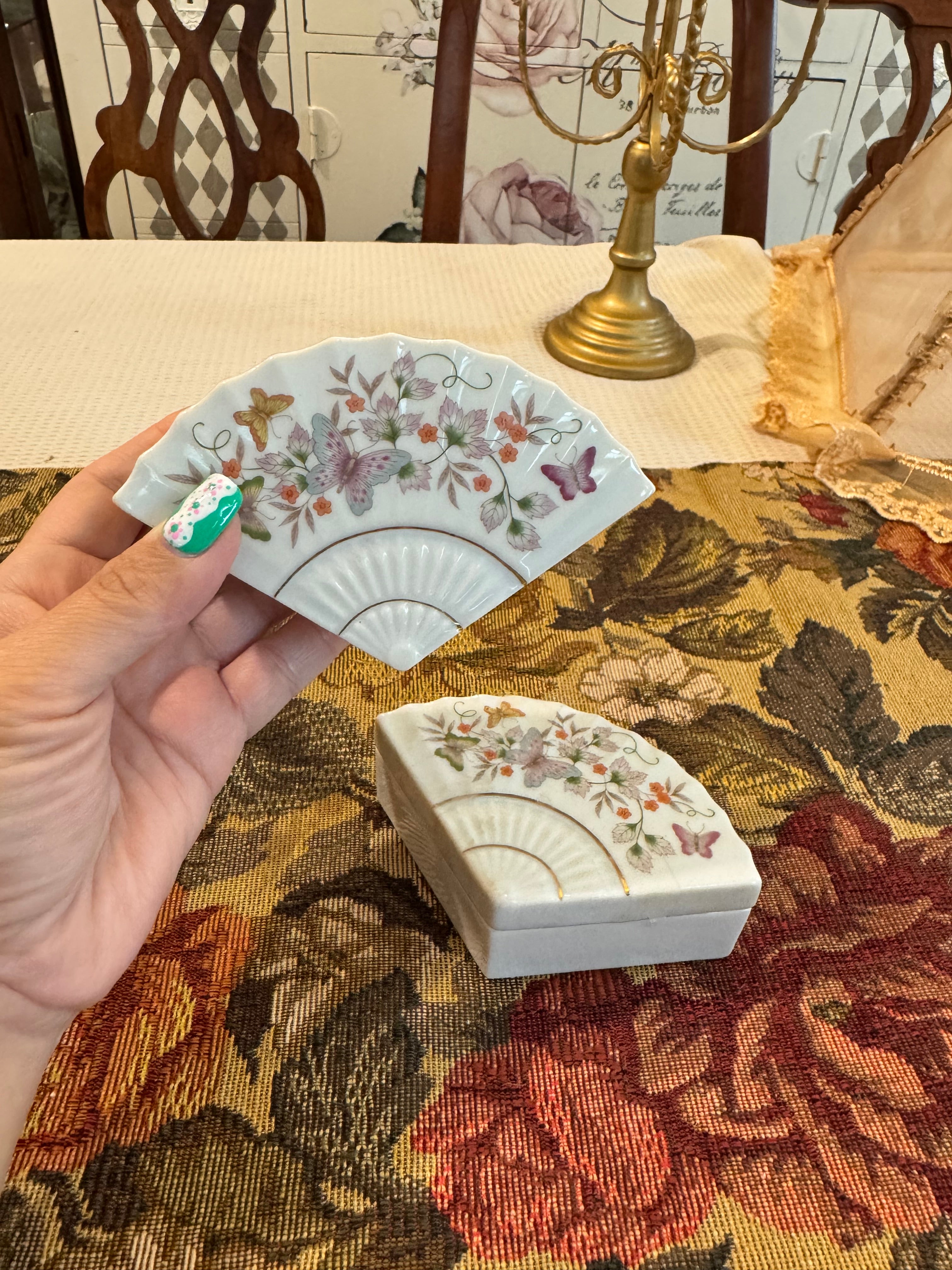 A pair of vintage 1980 Avon porcelain fan-shaped trinket boxes